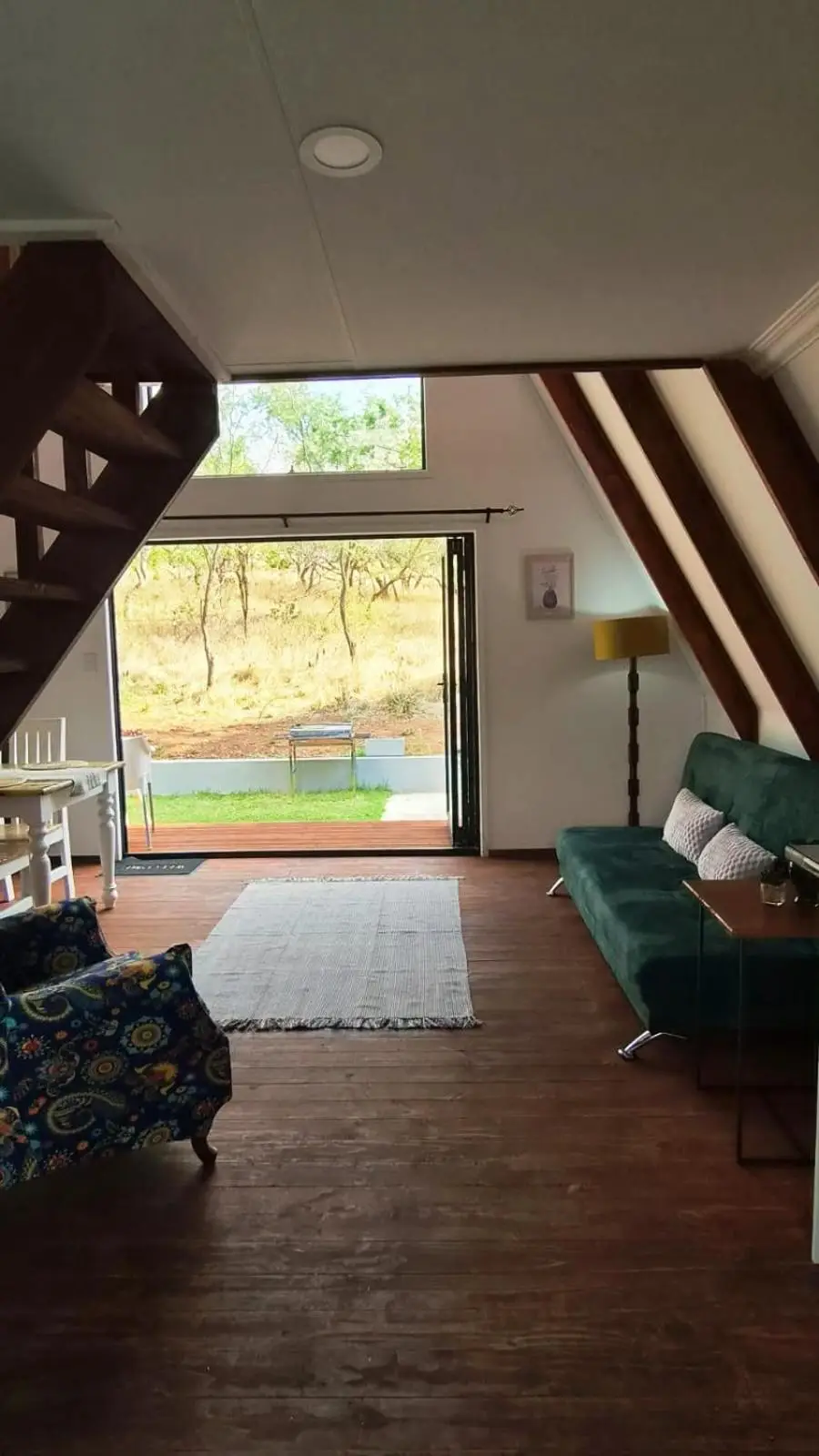 The living room, looking out through the glass doors to the bush